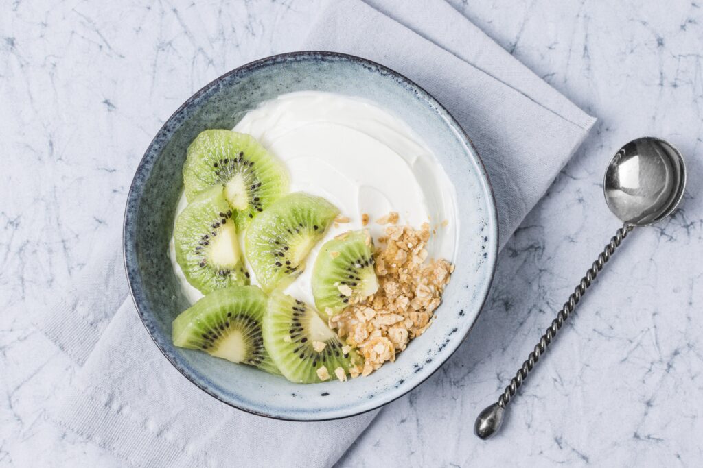 Top view breakfast bowl with kiwi oats