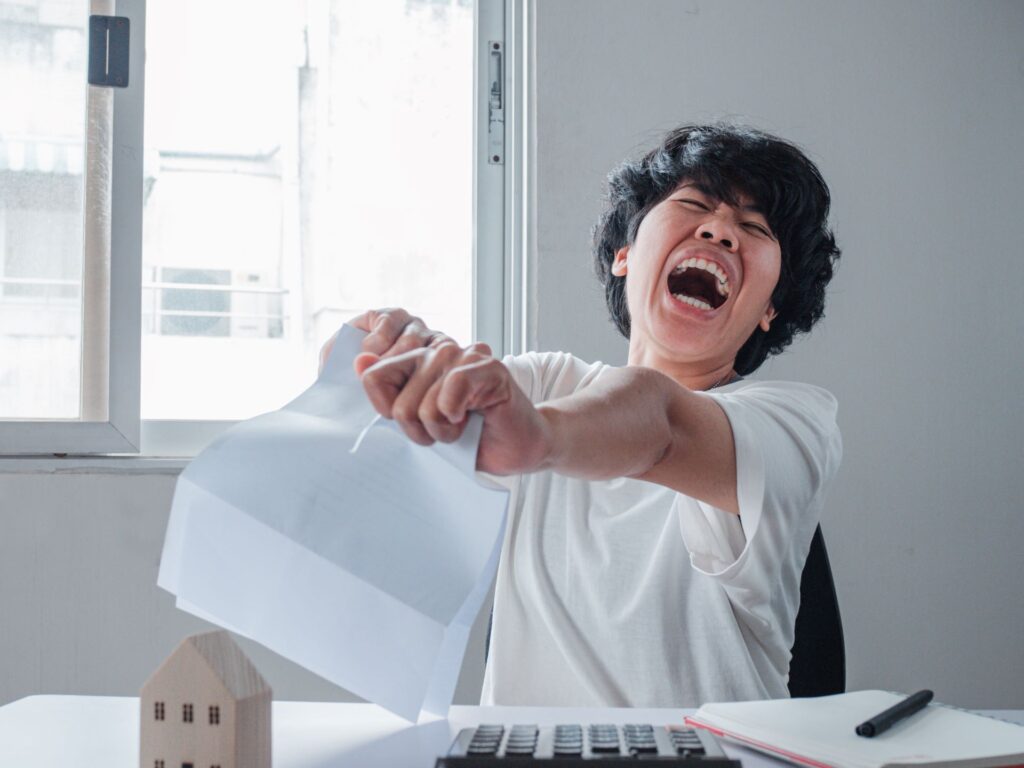 Angry woman tearing letter bills feeling desperate about financial problems dismissive notice failed test