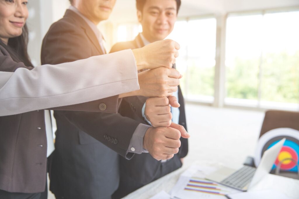 Business people stacking hands table