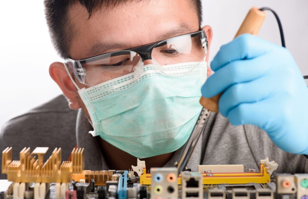 Close up engineer repairing circuit board
