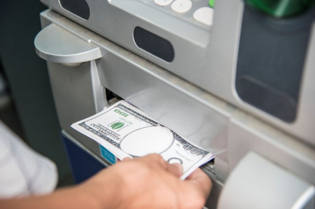 Closeup hand getting money from atm